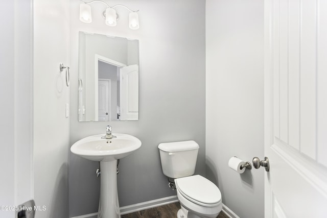 bathroom featuring toilet and hardwood / wood-style flooring