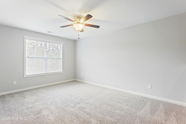 spare room featuring ceiling fan and carpet floors