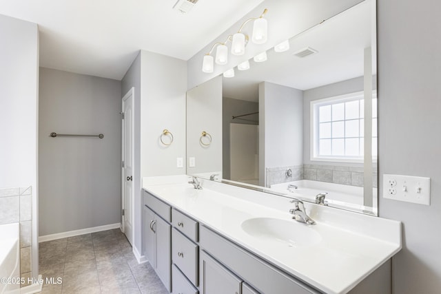 bathroom featuring vanity, tile patterned flooring, and a bathtub