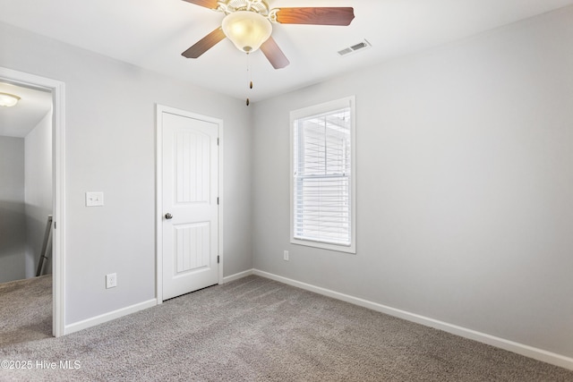 unfurnished bedroom featuring light carpet and ceiling fan