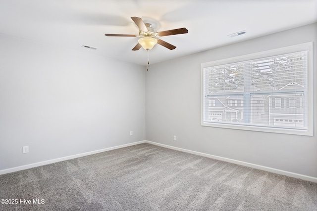 unfurnished room with ceiling fan and carpet flooring