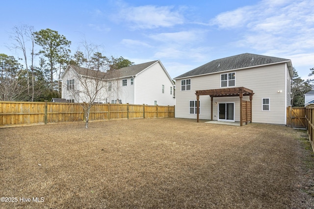 rear view of house featuring a pergola and a patio