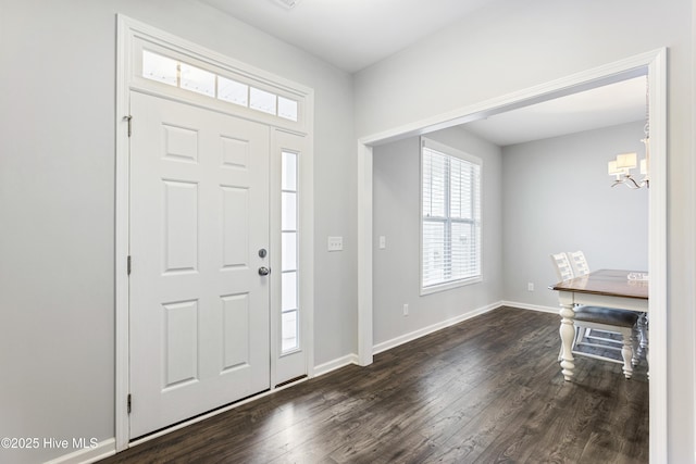 foyer featuring a notable chandelier and dark hardwood / wood-style flooring