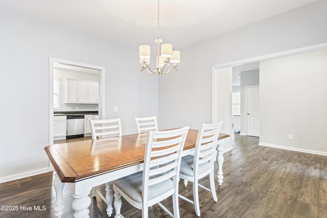 dining area featuring dark hardwood / wood-style floors and a chandelier