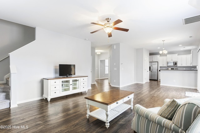 living room featuring dark hardwood / wood-style flooring and ceiling fan