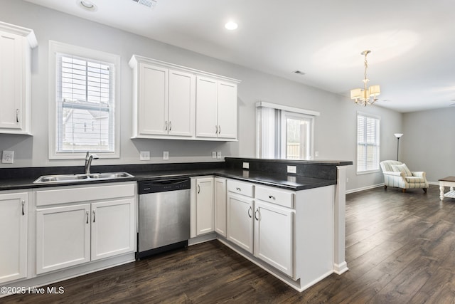 kitchen featuring decorative light fixtures, white cabinets, stainless steel dishwasher, and sink