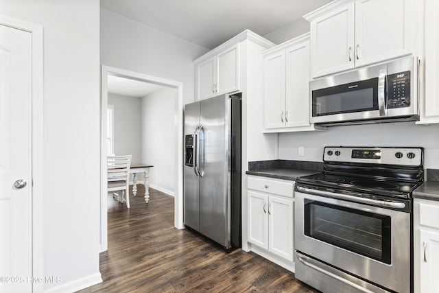 kitchen with stainless steel appliances, white cabinets, and dark hardwood / wood-style flooring