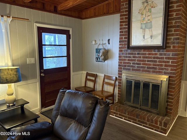 doorway to outside with a fireplace, dark wood-type flooring, beamed ceiling, and wood ceiling