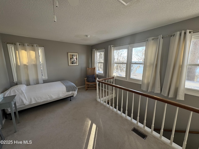 carpeted bedroom with a textured ceiling