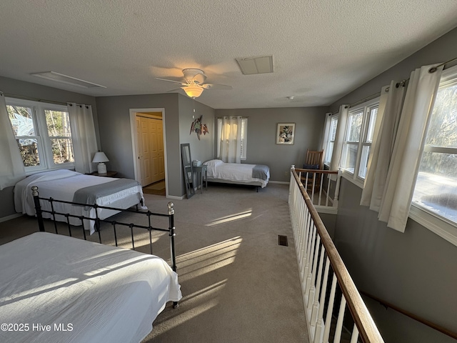 carpeted bedroom featuring ceiling fan, a closet, and a textured ceiling