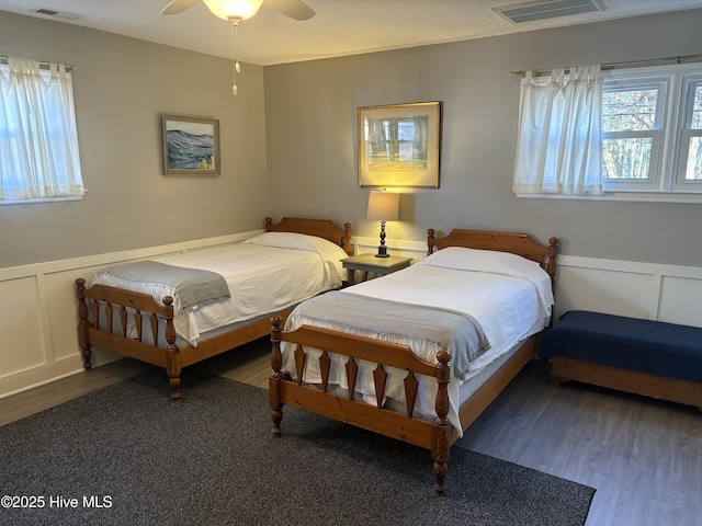 bedroom featuring ceiling fan and dark hardwood / wood-style flooring