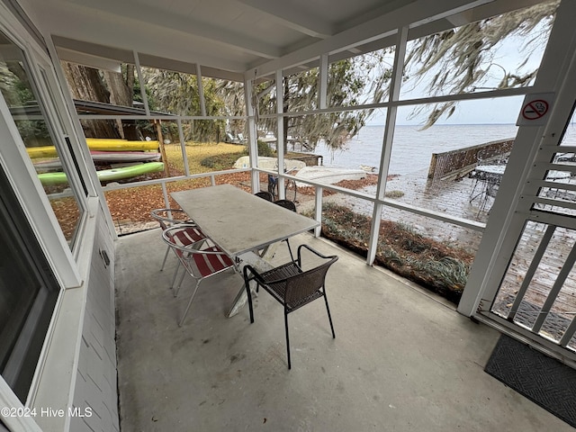 unfurnished sunroom with a water view