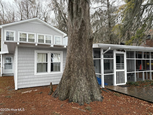 back of house featuring a sunroom