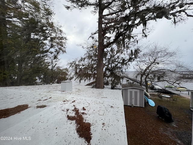 snowy yard with a storage unit