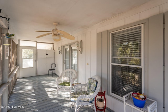 sunroom / solarium featuring ceiling fan