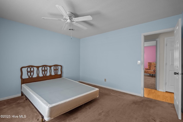 bedroom with ceiling fan, baseboards, and carpet flooring