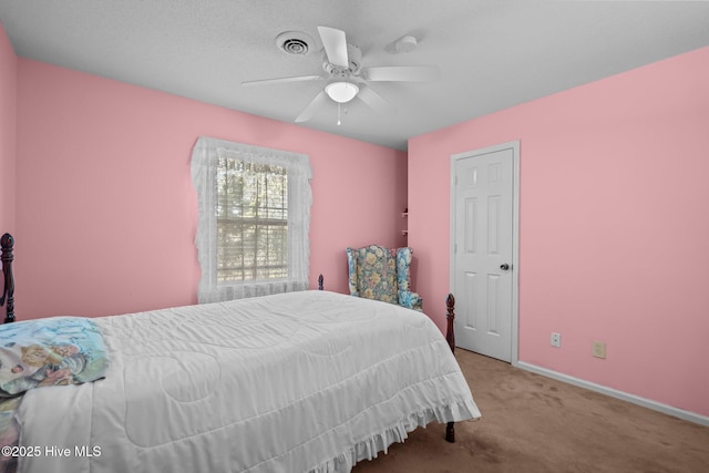 bedroom with baseboards, a ceiling fan, visible vents, and light colored carpet