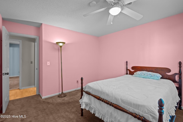 bedroom featuring dark carpet, baseboards, and ceiling fan