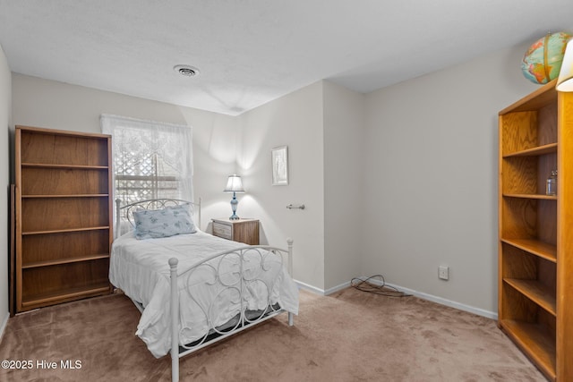 carpeted bedroom with visible vents and baseboards