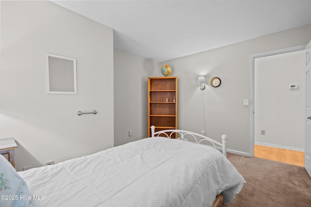 bedroom with carpet floors and baseboards