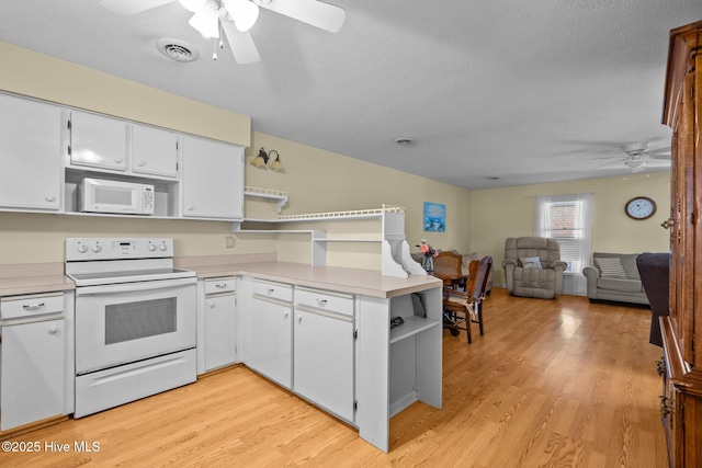 kitchen featuring open shelves, light countertops, open floor plan, white cabinets, and white appliances