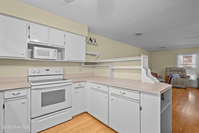 kitchen featuring open shelves, white appliances, white cabinets, and light countertops