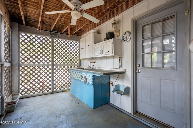 view of patio with a ceiling fan and a sink