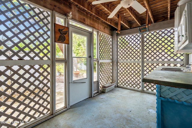 unfurnished sunroom with a sink and ceiling fan