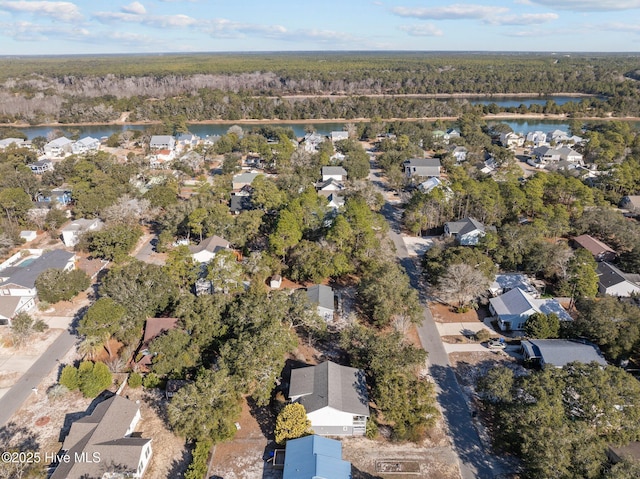 aerial view featuring a residential view, a water view, and a view of trees