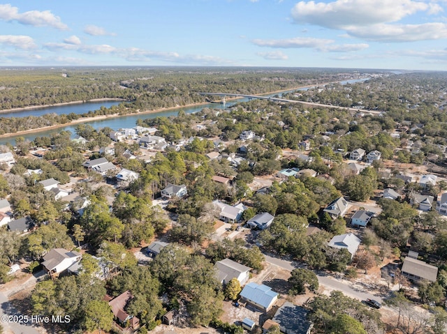 birds eye view of property with a water view, a residential view, and a view of trees