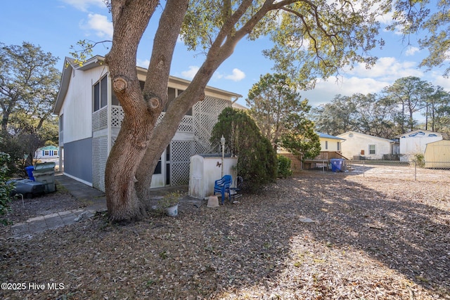 view of side of home with fence