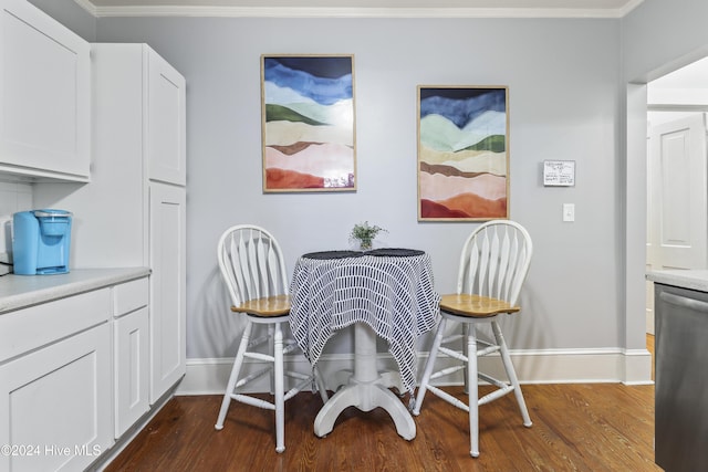 dining area featuring ornamental molding and dark wood-type flooring