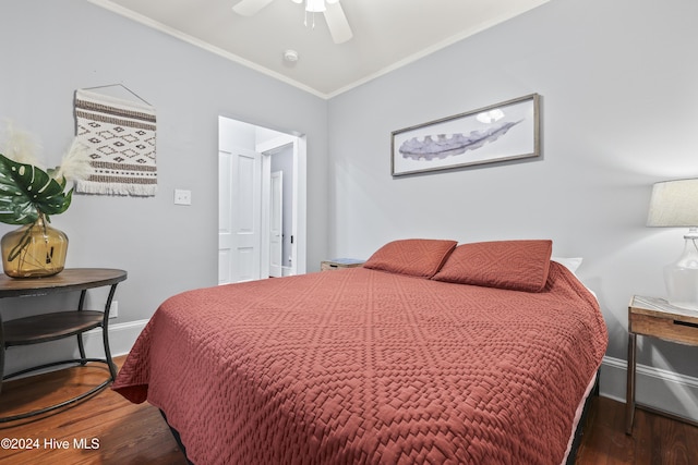 bedroom with ceiling fan, ornamental molding, and dark wood-type flooring