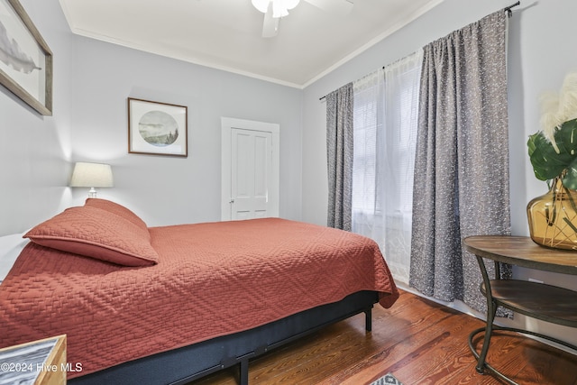 bedroom featuring ceiling fan, dark hardwood / wood-style flooring, and crown molding