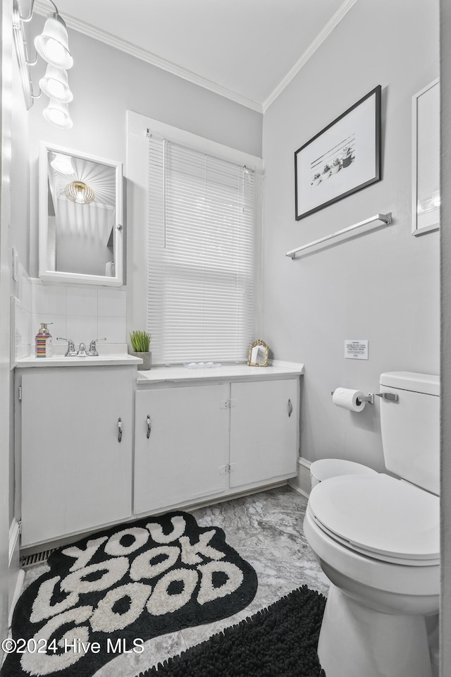 bathroom featuring vanity, toilet, and crown molding