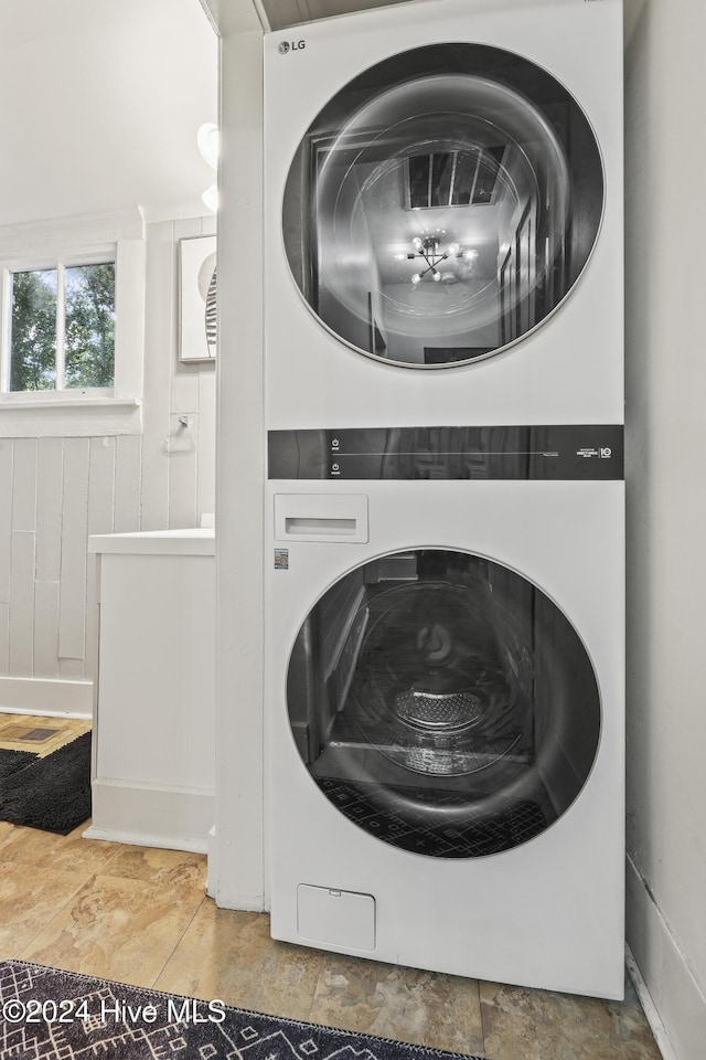 laundry room with stacked washer / drying machine