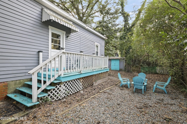 view of yard with a wooden deck and a shed