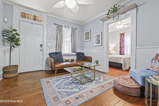 living room with ceiling fan, crown molding, and hardwood / wood-style flooring