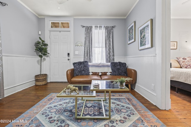 living room featuring wood-type flooring and ornamental molding