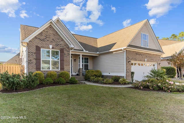 view of front of home with a front yard and a garage