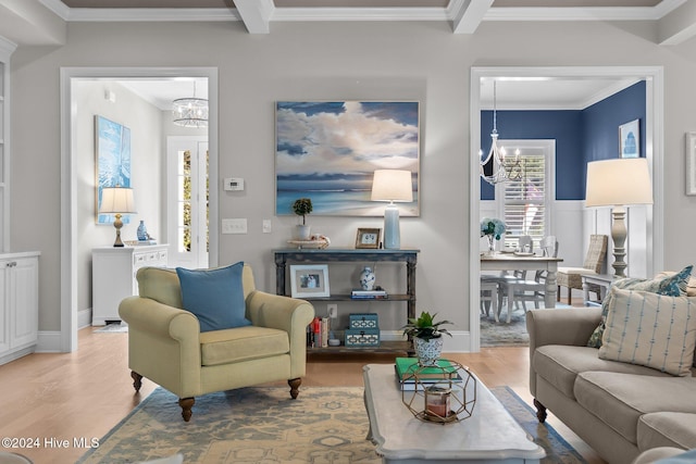 living room with hardwood / wood-style floors, ornamental molding, and a chandelier