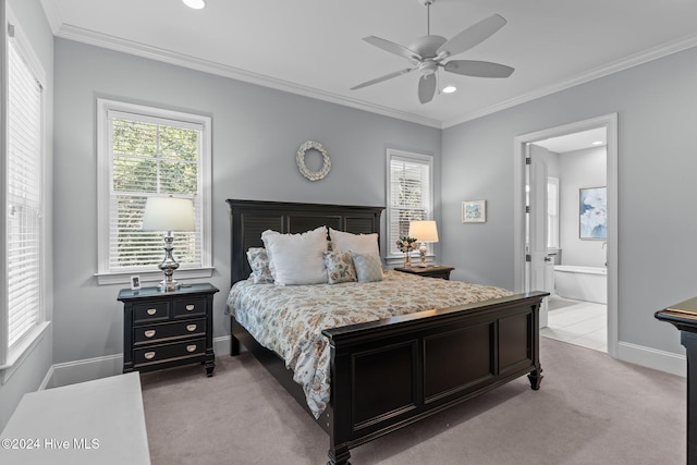 carpeted bedroom with multiple windows, ensuite bathroom, ceiling fan, and crown molding