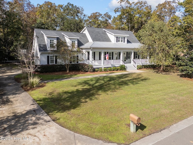 cape cod-style house featuring a porch and a front yard