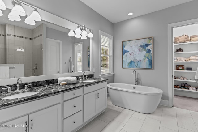 bathroom with tile patterned floors, vanity, and plus walk in shower