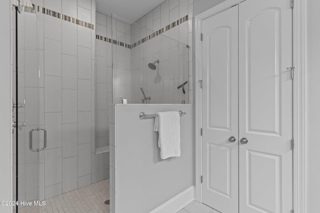 bathroom featuring tile patterned floors and an enclosed shower