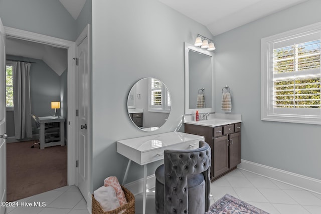 bathroom with tile patterned flooring, vanity, a healthy amount of sunlight, and vaulted ceiling