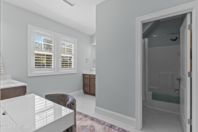 bathroom featuring tile patterned flooring, vanity, and shower / bath combo