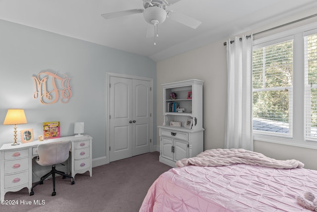 bedroom featuring ceiling fan, vaulted ceiling, light colored carpet, and a closet