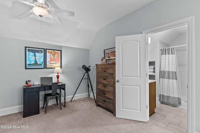 home office with ceiling fan, light colored carpet, and vaulted ceiling