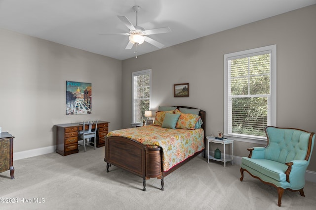 bedroom featuring ceiling fan and light carpet